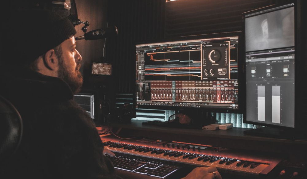 Producer working at a mixing console in a studio
