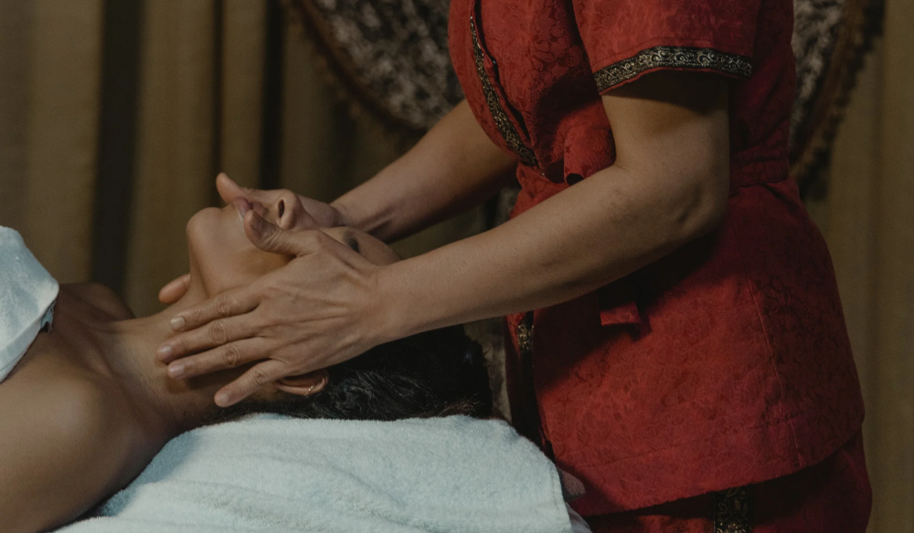 Therapist giving a head massage
