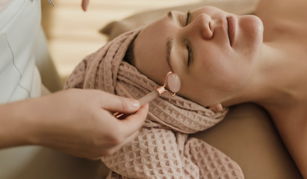Client receiving a gua sha facial massage