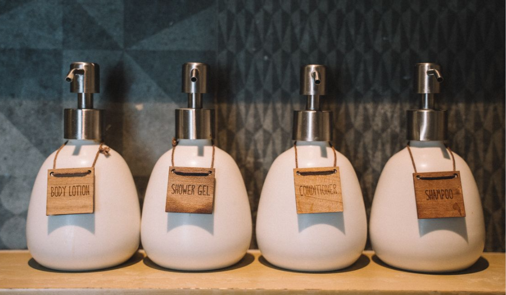 Row of refillable lotion and soap dispensers