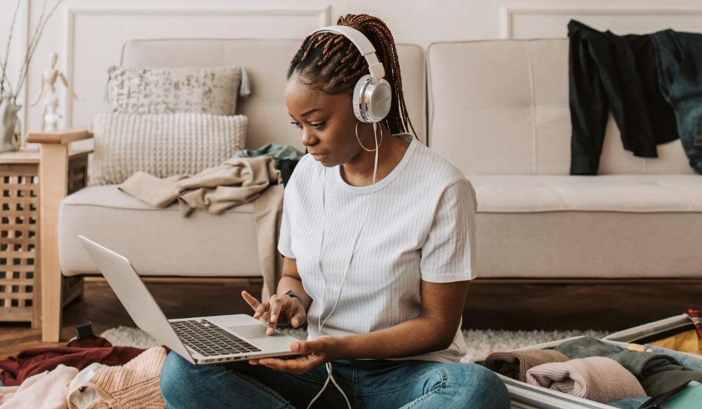 Woman with headphones working on a laptop at home