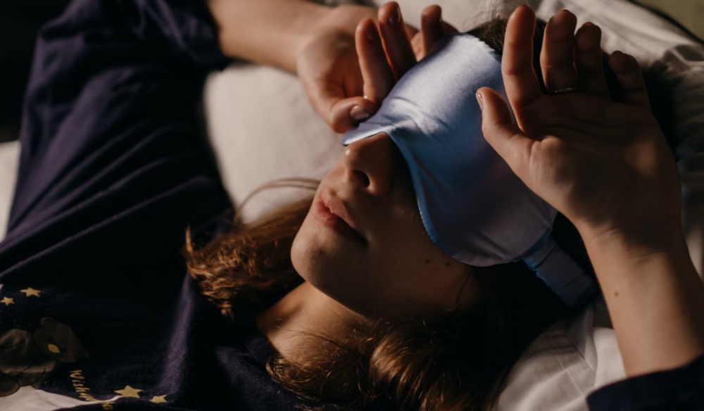 Person resting with a cooling eye mask