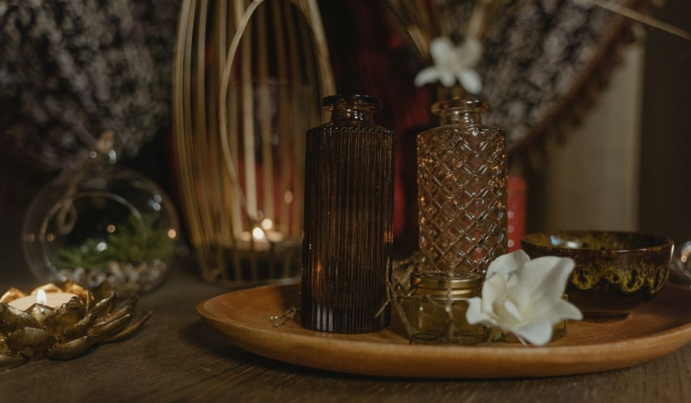 Perfume bottles and flowers on a spa tray