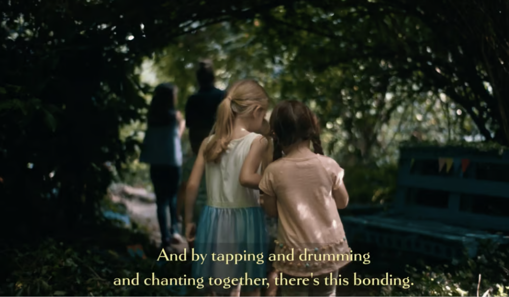 Still from In Pursuit of Wellness, children playing beneath a tree