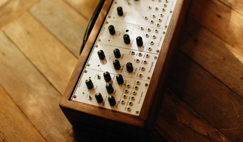 Modular synthesiser on a wooden floor