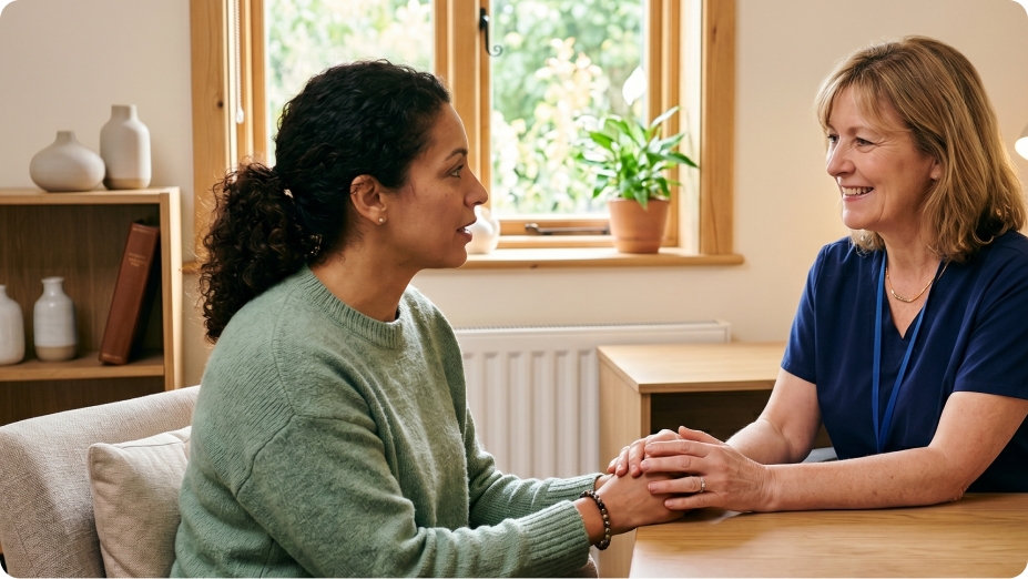 Practitioner holding a patient's hands during a calm consultation
