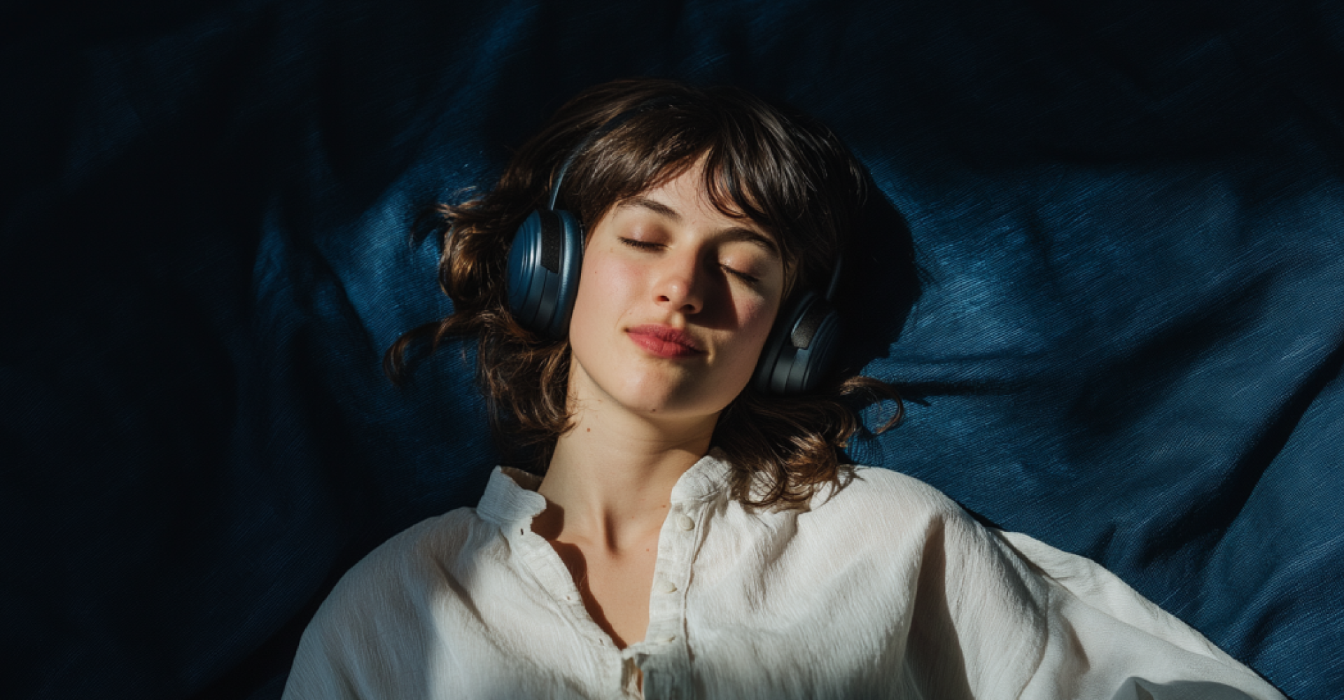 Woman listening to music with headphones, eyes closed
