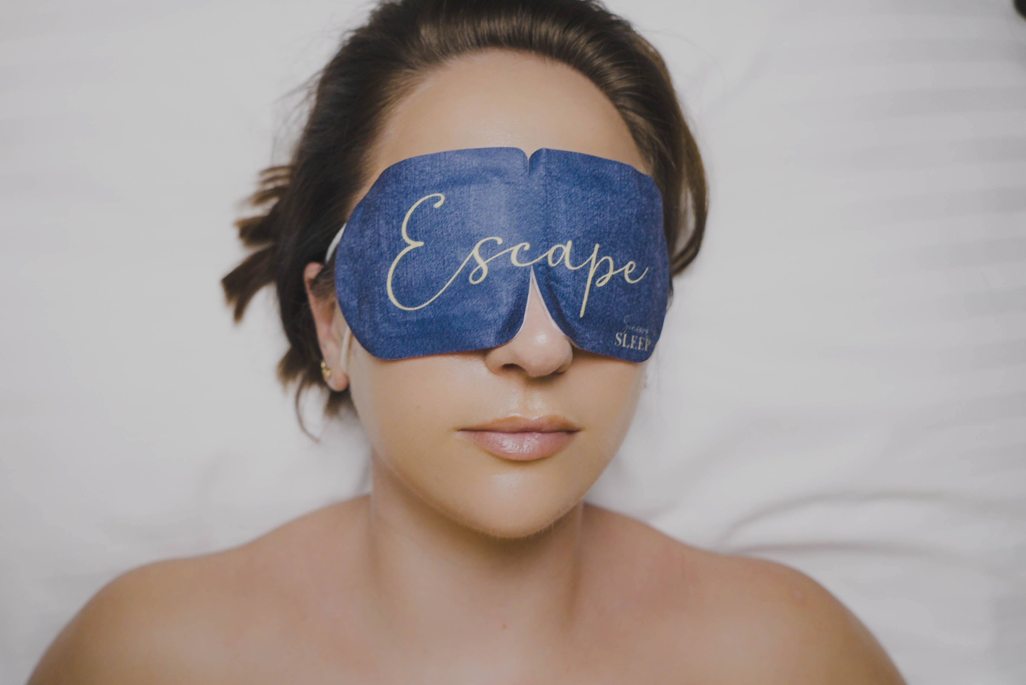 Sound Escape treatment on a phone beside a client wearing an eye mask