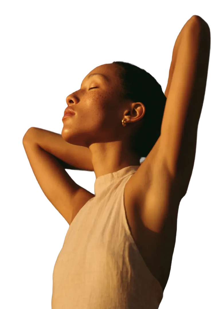 Woman stretching with eyes closed in warm natural light