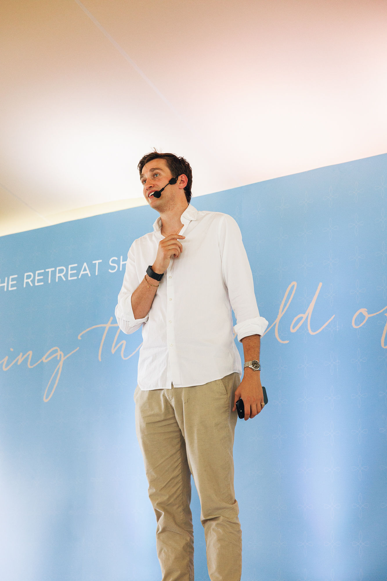 Speaker with a microphone on stage at a wellness event