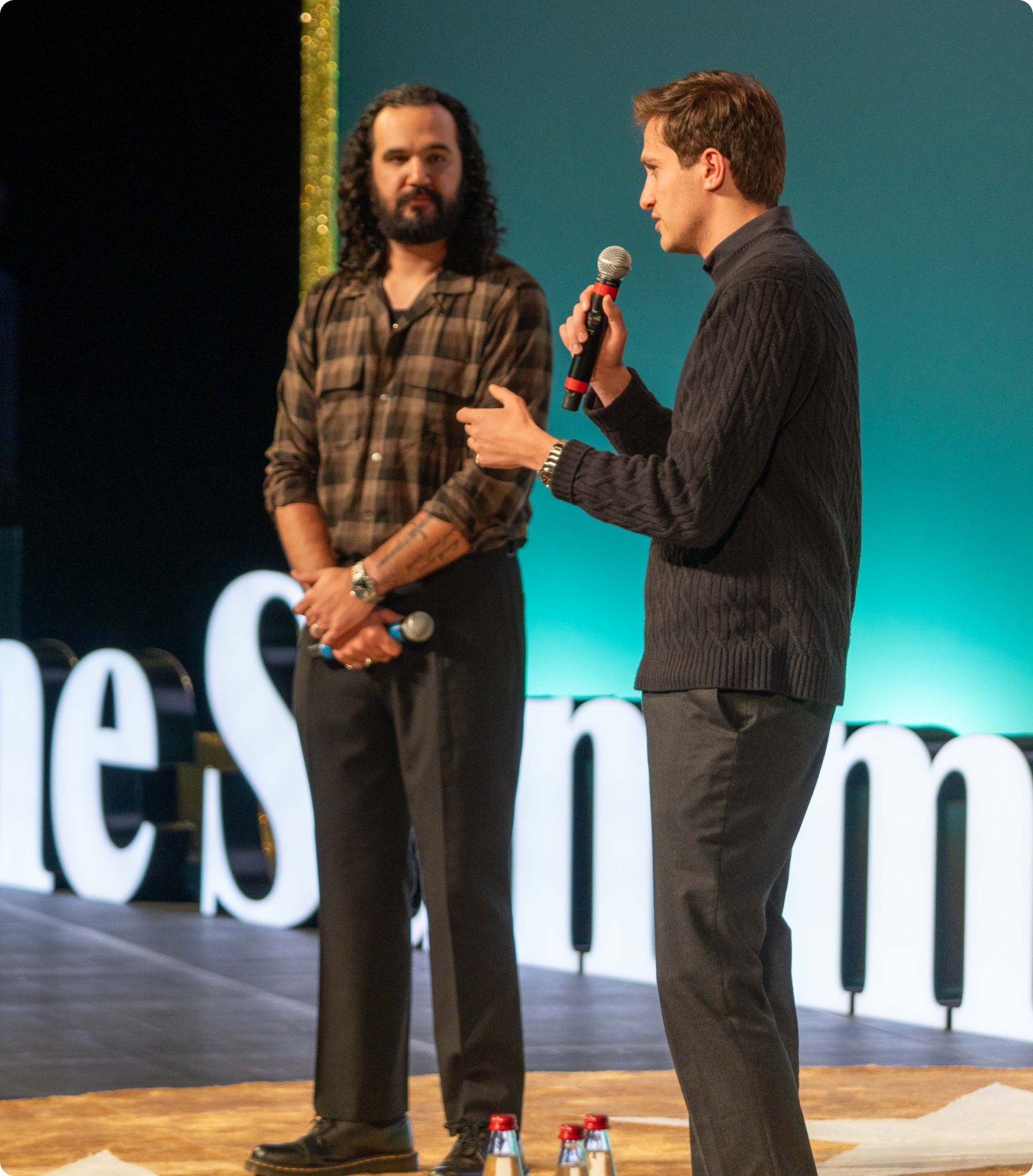 Two speakers in conversation on stage at The Summit