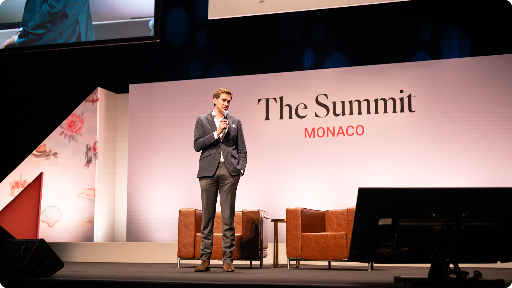 Presenter on stage at The Summit by Forbes Travel Guide in Monaco