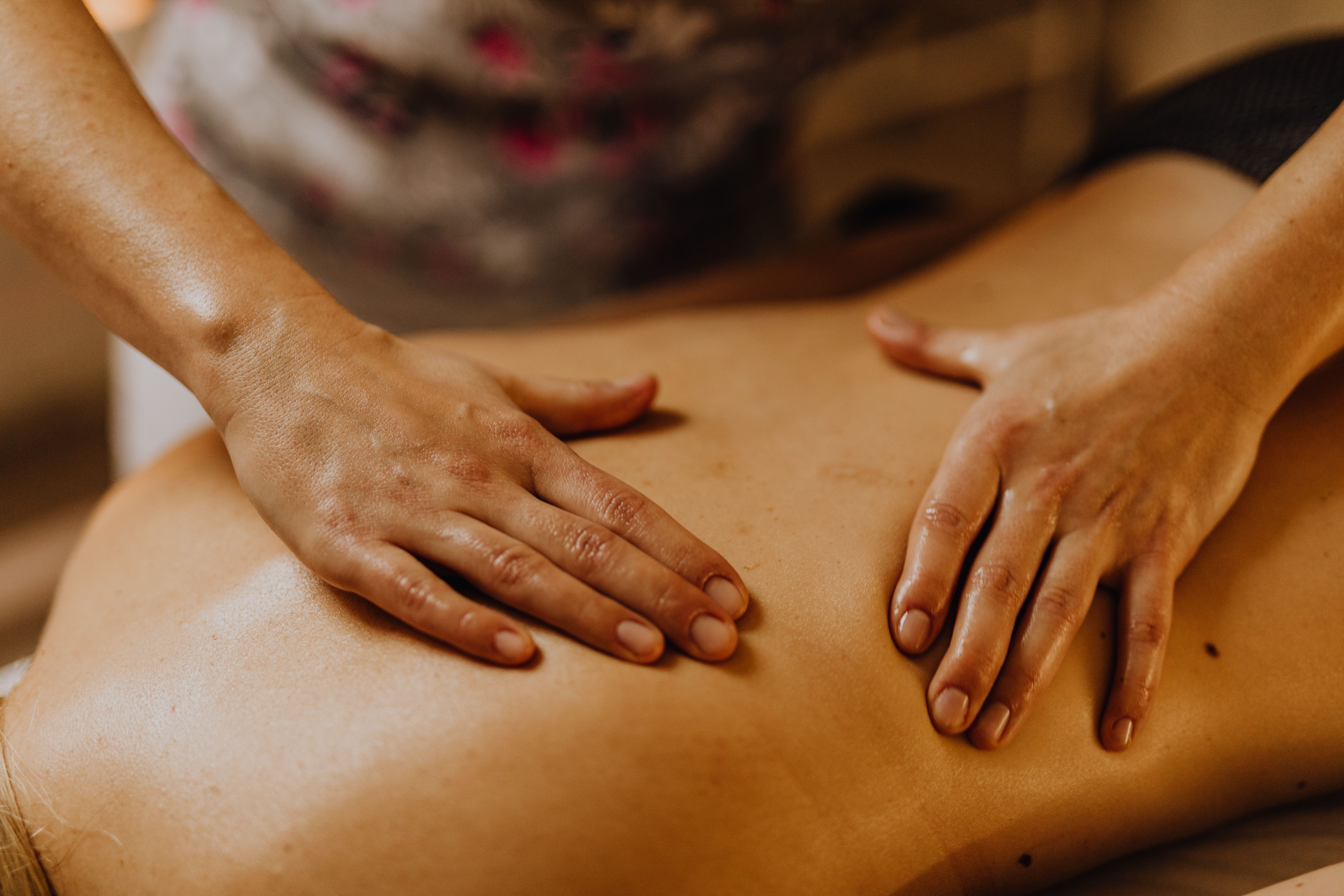 Massage therapist's hands on a client's back