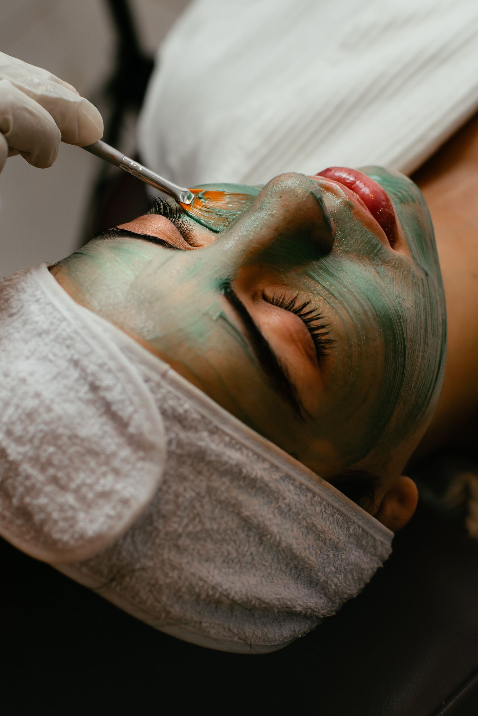 Guest receiving a facial treatment at a spa.