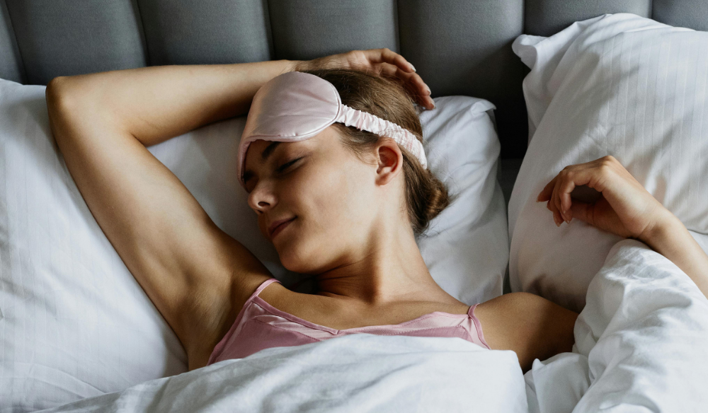 Woman sleeping with a sleep-tracking headband